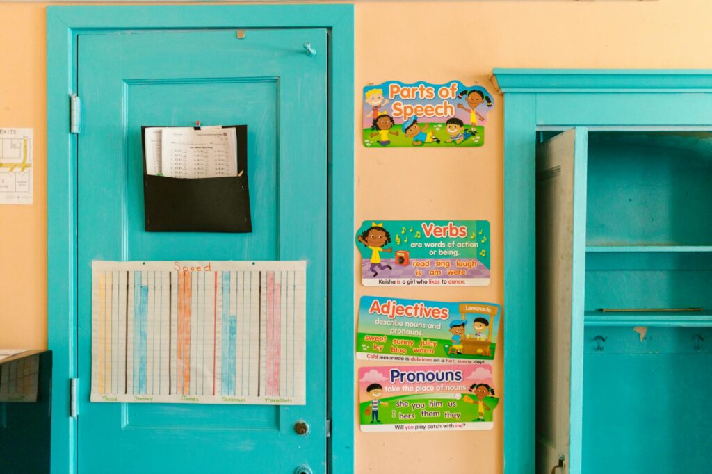 Vibrant kindergarten wall with educational posters and blue door.